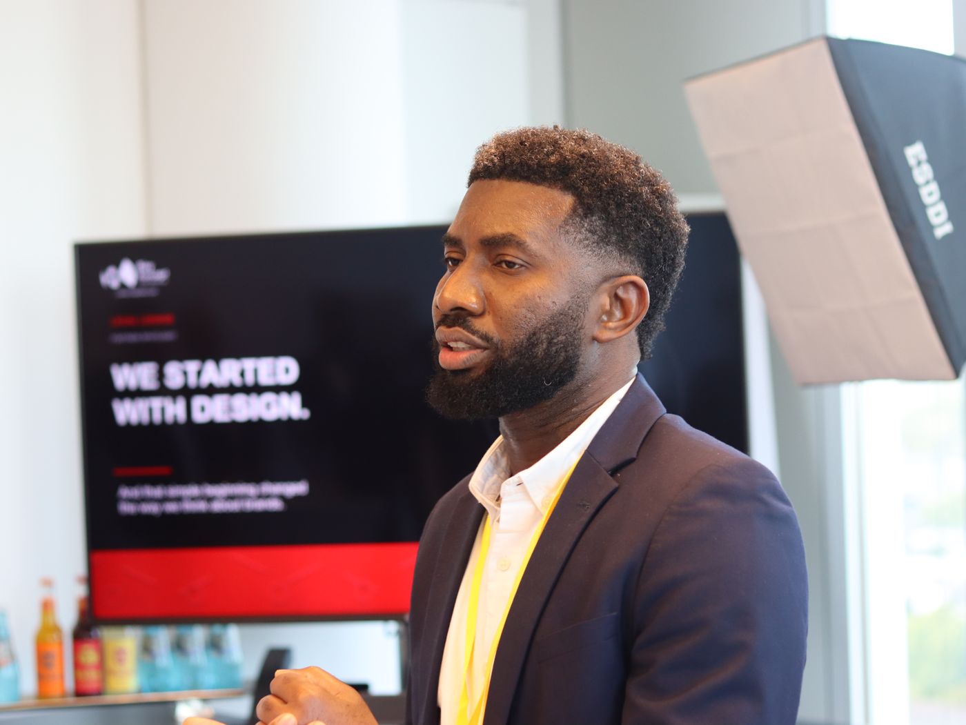 Jerry speaking at an event in front of a screen