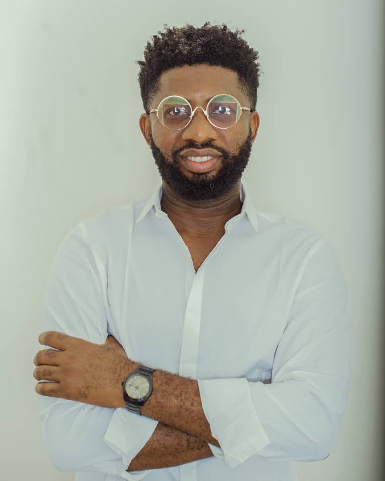 Jerry smiling in a white shirt and glasses
